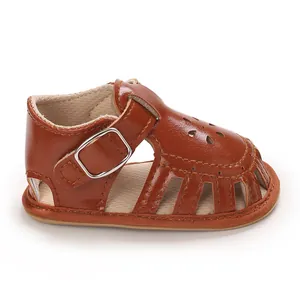Detailed side view of a brown faux leather baby girl walking sandal with soft sole
