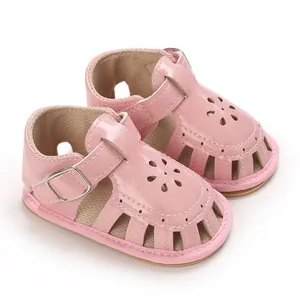 Detailed view of pink baby walker sandals with flower cutouts and soft soles.