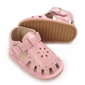 Detail view of pink baby girl sandals with flower cutouts and soft sole