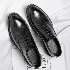Elegant black men's brogue elevator shoes with hollow perforated wingtip design for business