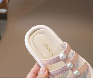 Vista detallada de sandalias rosas para niña con perlas elegantes y cómoda suela suave.