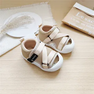 Detailed view of beige baby mesh walking sandals with closed-toe and Velcro straps