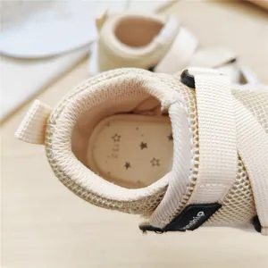 Close-up of baby walking sandals showing breathable mesh and 130 size mark.