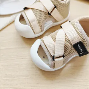 Close-up of breathable mesh baby walking sandals with secure velcro strap closure.