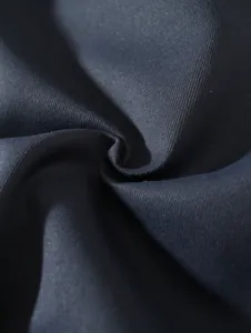 Macro detail of dark navy woven fabric showing fine textile texture and quality weave.