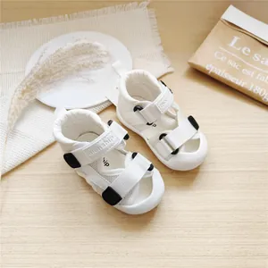 Close-up of white baby walking sandals with breathable mesh and velcro straps