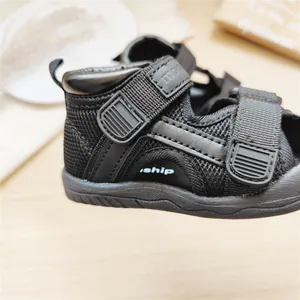 Detail view of black toddler walking sandals with mesh fabric and hook-and-loop straps
