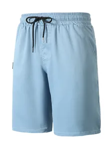 Close-up detail of light blue men's casual woven summer beach shorts with black drawstring