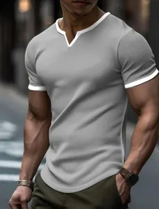 Detailed view of a men's grey textured knit t-shirt with a stylish white V-notch collar.