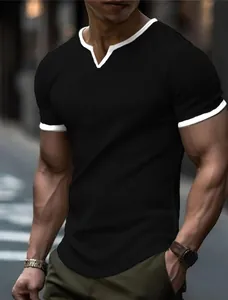Close-up of men's black V-neck t-shirt with white contrast collar and sleeve trim