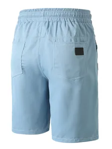 Detail showing the back pockets and elastic waistband of light blue beach shorts