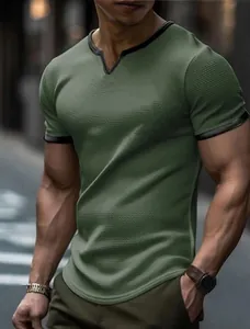 Detailed view of men's olive green waffle knit T-shirt featuring a V-neck with black trim