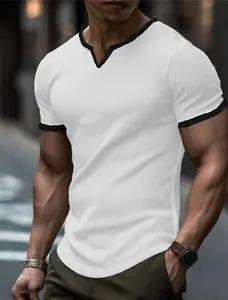 Detailed texture of men's white V-neck T-shirt with contrast black trim and grid pattern fabric
