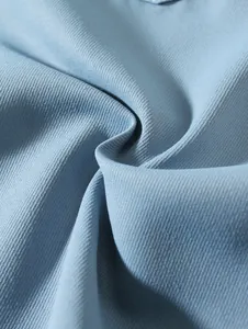 Close-up macro view showing the light blue woven fabric texture of men's summer beach shorts