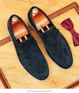 Detail of navy blue suede loafers with soft sole and elegant gentleman styling