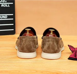 Close-up rear view of men's premium brown suede loafers with comfortable white soft sole