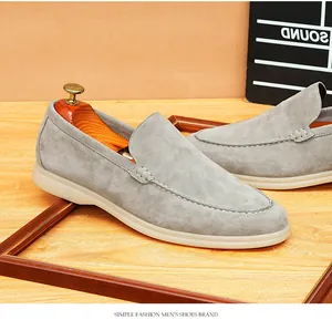 Macro detail of grey suede slip-on loafers showing fine stitching and soft cashmere texture