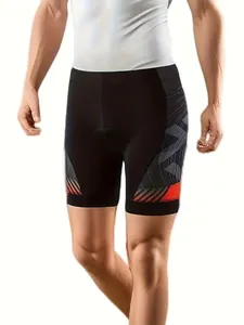 Close-up detail of black cycling shorts featuring padded seat and orange patterns.