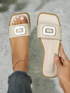 Elegant cream square toe flat sandals for women featuring a sparkling rhinestone buckle