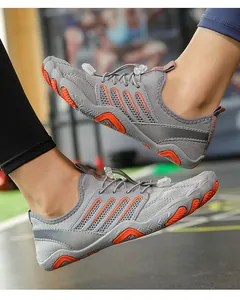 Dynamic side view of grey and orange breathable water shoes for swimming and beach