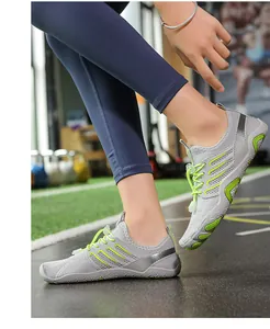 Lightweight grey and green mesh fitness shoes shown being worn in a professional gym setting
