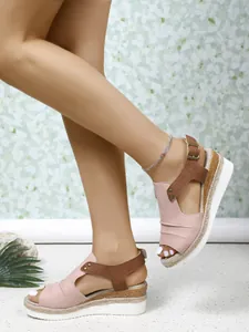 Detail view of pink and brown wedge sandals with peep toe and rope-wrapped sole.