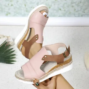 Detail view of pink and brown women's wedge sandals with braided rope sole