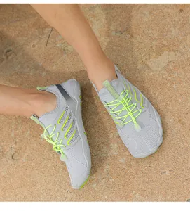 Macro view of grey quick-dry beach wading shoes featuring vibrant neon green laces