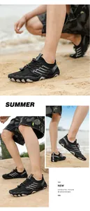 Professional action shots of breathable black barefoot water shoes on a sandy beach