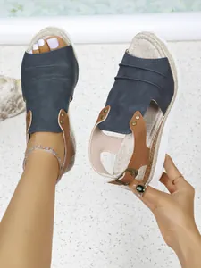 Detailed view of women's peep toe wedge sandals with espadrille platform sole