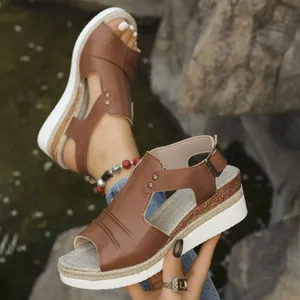 Detail view of brown peep-toe wedge sandals with espadrille rope-wrapped soles
