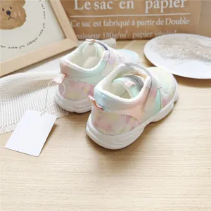 Detailed back view of pastel rainbow gradient mesh sneakers for children on wood
