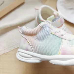 Close-up detail of breathable children's sneakers with a cute pastel gradient pattern.