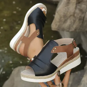 Detailed macro view of wedge sandals featuring hemp-braided platform and rivets.