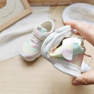 Close-up showing the flexible soft-sole of children's pastel gradient mesh sneakers