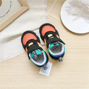 Detail view of vibrant children's rainbow gradient mesh sneakers with breathable fabric.