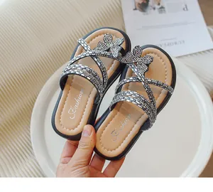 Detalle de acentos de mariposa de diamantes de imitación en elegantes zapatillas de princesa