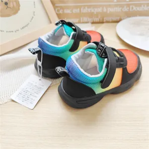 Detailed view of the vibrant rainbow gradient mesh and velcro straps on kids' sneakers