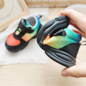 Detail shot showing the extreme flexibility and soft sole of the gradient mesh kids sneaker.