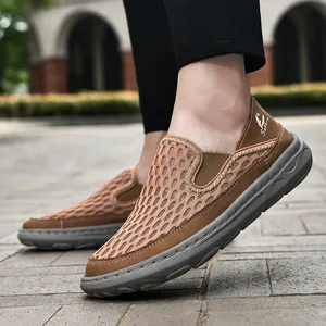 Detail view of men's breathable brown mesh casual shoes with hand-stitched grey rubber sole