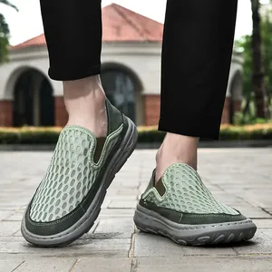 Detailed view of men's breathable green mesh slip-on casual shoes worn outdoors