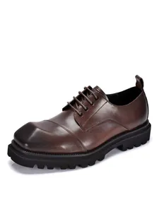 Detailopname van bruine heren Derby schoenen van echt leer met dikke profielzool.