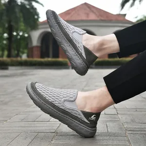 Side view of men's breathable mesh loafers with flexible soft soles in a park setting