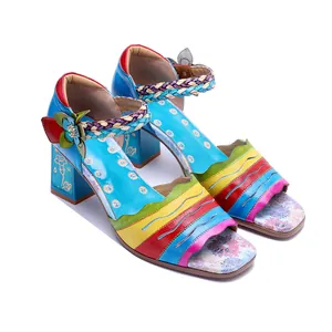 Detail of colorful vintage patchwork genuine leather high-heeled sandals with floral decor.