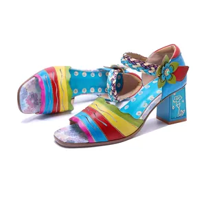 Detail view of handmade vintage patchwork leather block heel sandals with floral accents