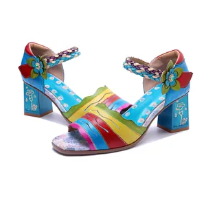 Detail showing handmade vintage patchwork leather sandals with colorful floral accents.