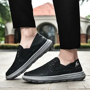 Close-up of men's breathable black mesh loafers with durable grey rubber soles