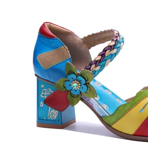 Close-up detail of vintage handmade leather sandal with colorful floral patchwork ornament