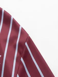 Detailed macro view showing high-quality stitching and fabric texture of a striped polo shirt.