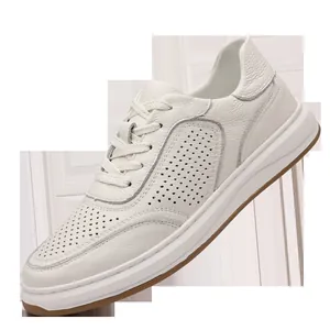 Close-up of white breathable genuine leather men's casual sneakers with textured finish